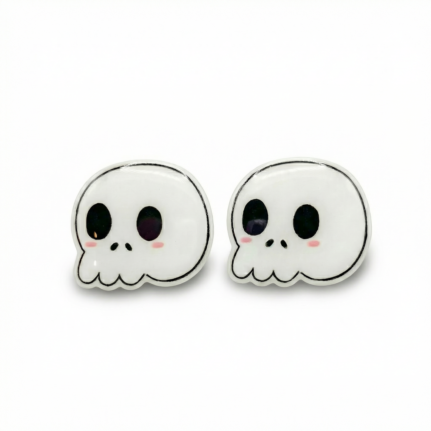 Pair of skull-shaped earrings with black eyes and pink cheeks on a white background