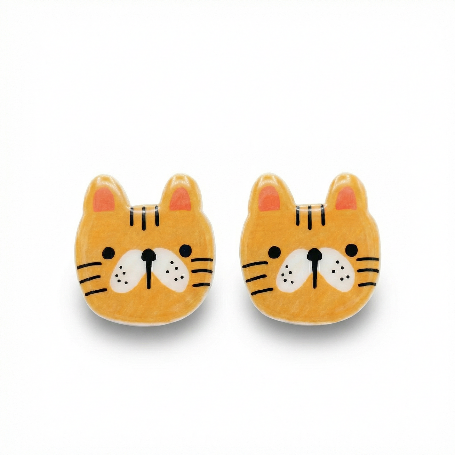 Pair of cute tiger face earrings on a white background