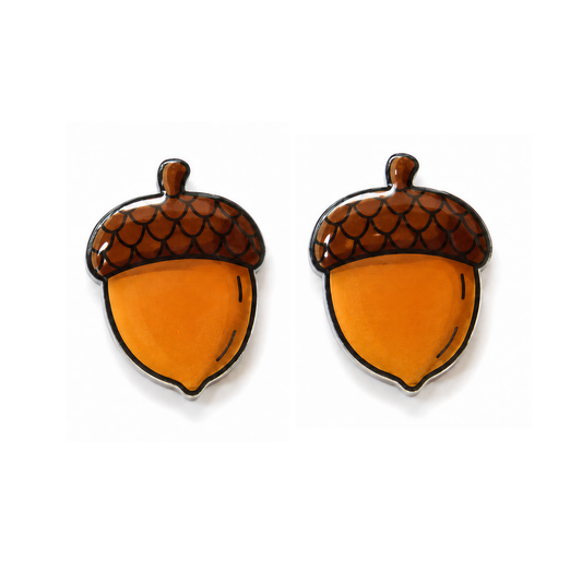 A pair of acorn-shaped stud earrings with glossy orange bodies and brown scaly caps outlined in black, displayed on a clean white background.