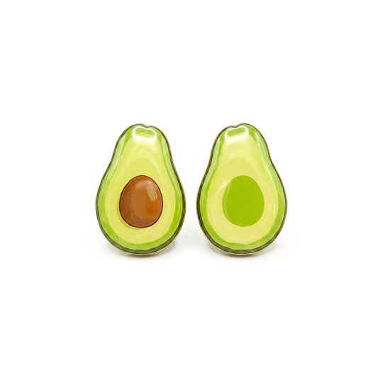 A pair of avocado-shaped stud earrings on a plain white background. One earring shows a brown pit, and the other shows a green flesh side, with a glossy finish.