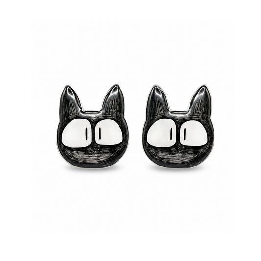 A pair of black and white cartoon cat face titanium stud earrings on a plain white background.