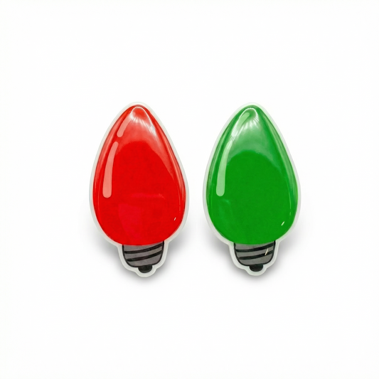 Red and green Christmas light bulb earrings on a white background