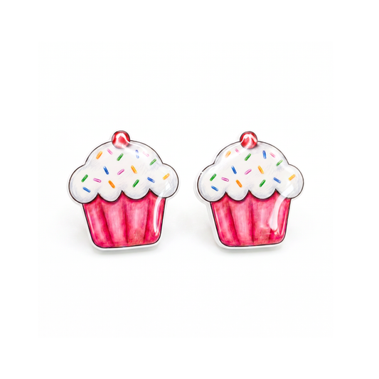 A pair of cupcake-shaped stud earrings with pink wrappers, white frosting, and colorful sprinkles on a plain white background.