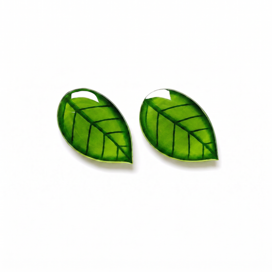 Pair of titanium stud earring with green leaf on white background