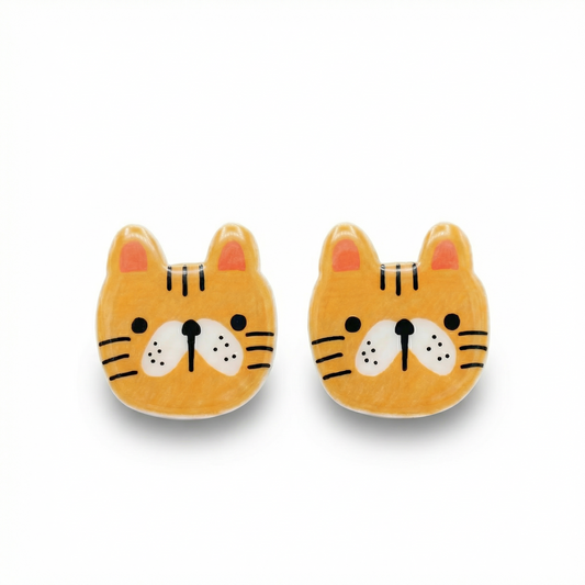 Pair of cute tiger face earrings on a white background