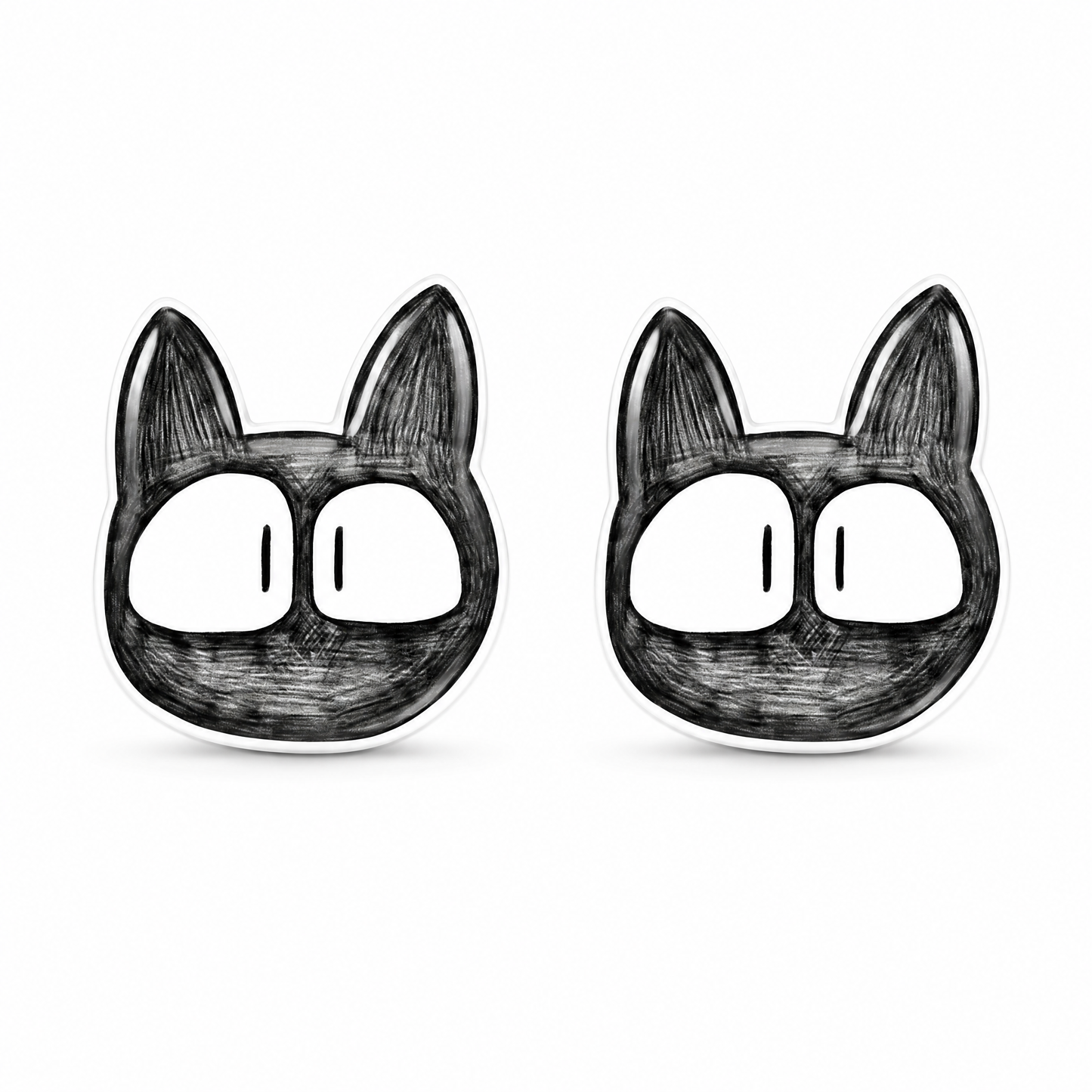 A pair of black and white cartoon cat face titanium stud earrings on a plain white background.