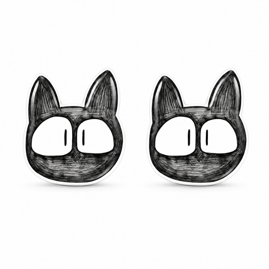 A pair of black and white cartoon cat face titanium stud earrings on a plain white background.