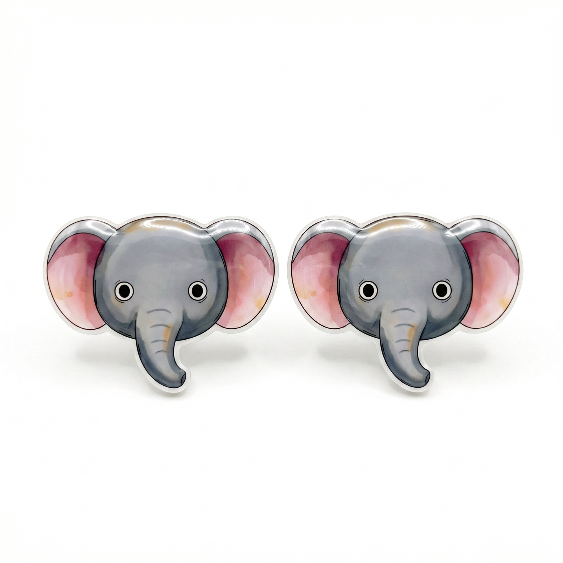 A pair of stud earrings shaped like cartoon elephant heads, featuring gray faces and trunks with pink inner ears and silver-tone edges, shown on a plain white background.