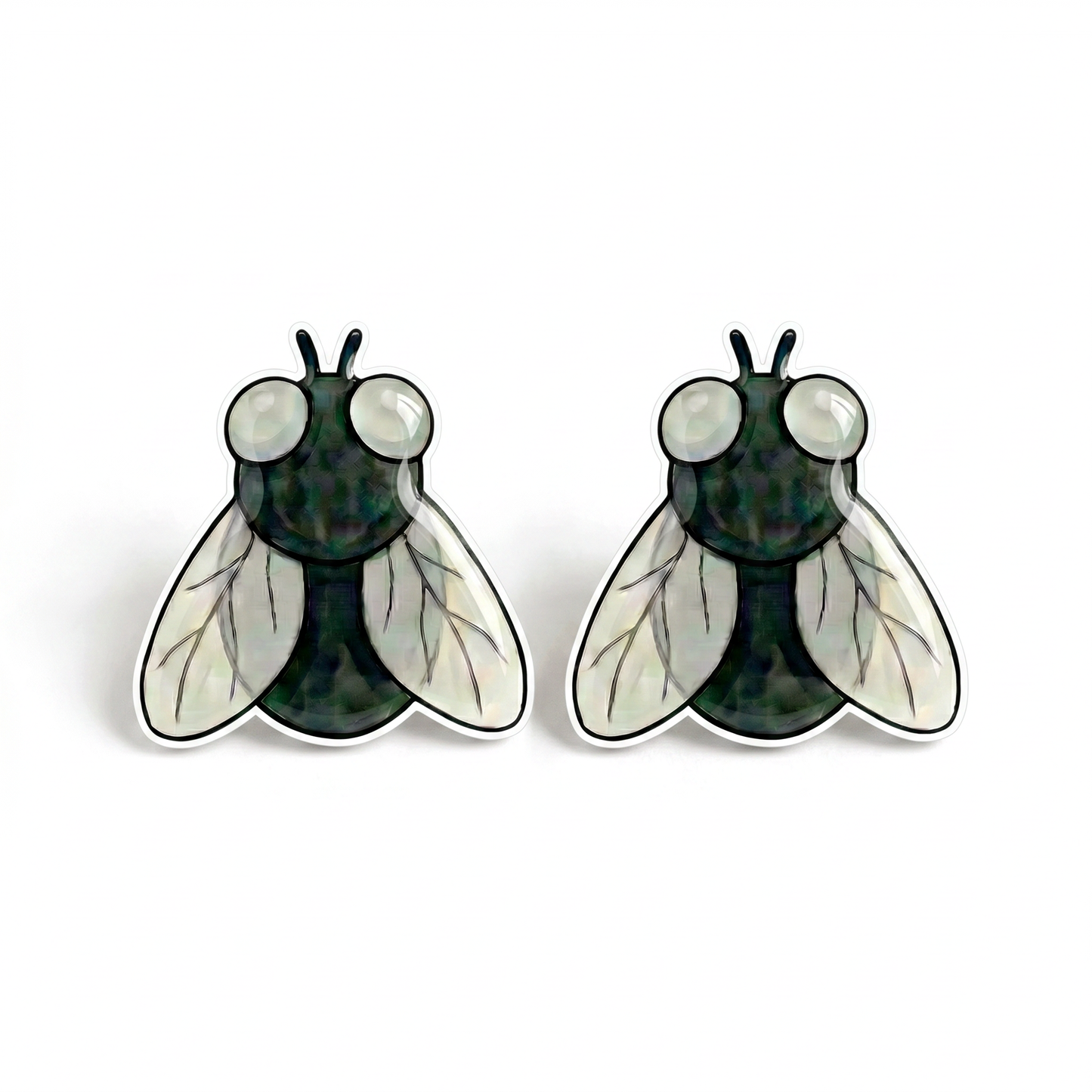 A pair of insect stud earrings shaped like flies, featuring a dark green textured body, large white eyes, and translucent white wings with black veining, set against a plain white background.