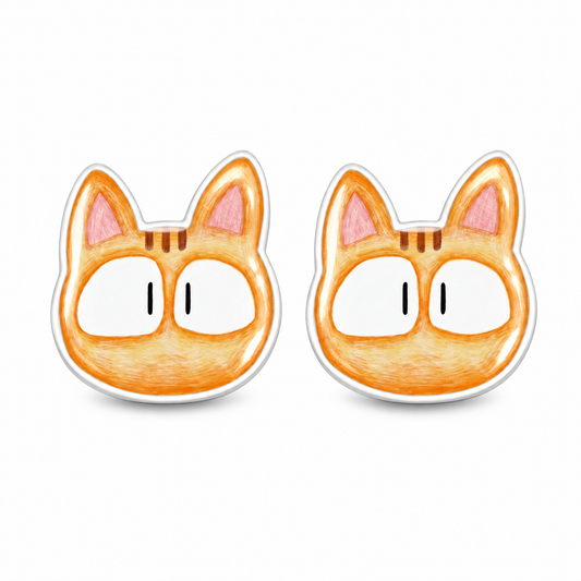 A pair of cartoon cat head stud earrings in orange, white, and pink, shown on a plain white background.