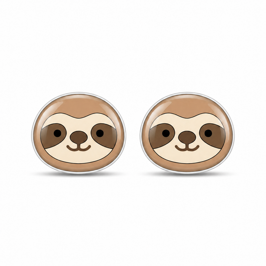 A pair of oval stud earrings featuring a cute cartoon sloth face design in shades of brown, beige, and black, set in a silver-toned metal on a white background.